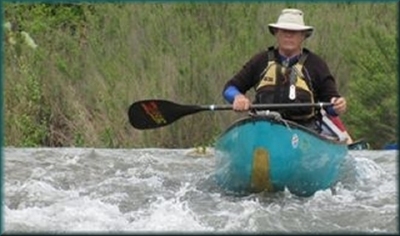 Canoeman paddling the South Llano River, Texas