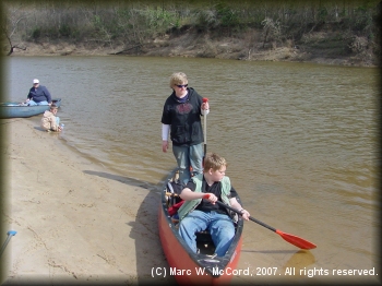 Arriving at one of many white sand beaches on the Sabine River