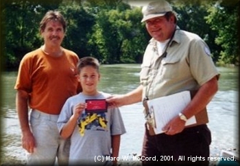 Marc and Will McCord accepting plaque from Mark Henneke for Second Place finish in the 2001 Come and Take It Race